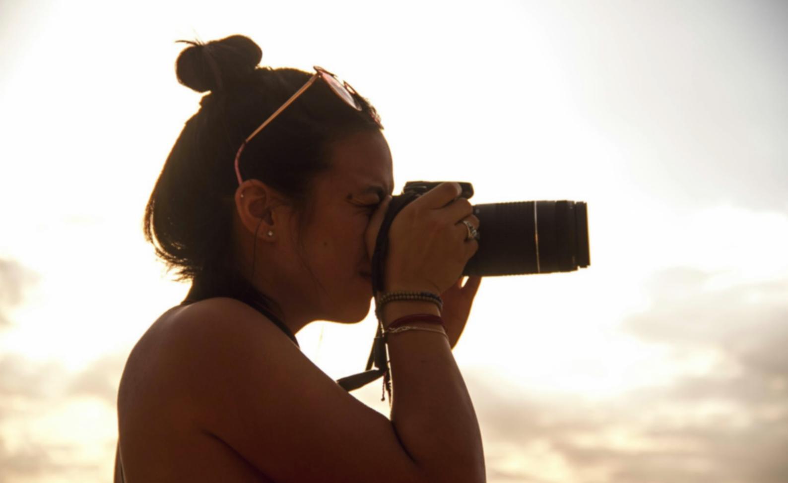 A photographer studying frame composition in natural light